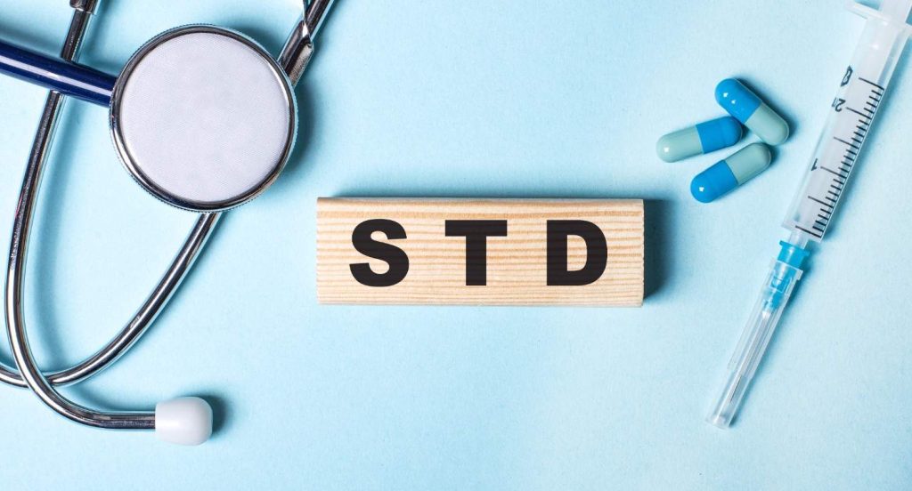 Close-up of "STD" blocks with healthcare tools, symbolizing accessible and cheap STD testing in Shenandoah