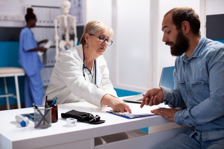 Same day STI test Houston: Doctor in white coat discussing results with patient in a bright clinic, offering rapid STI testing services.