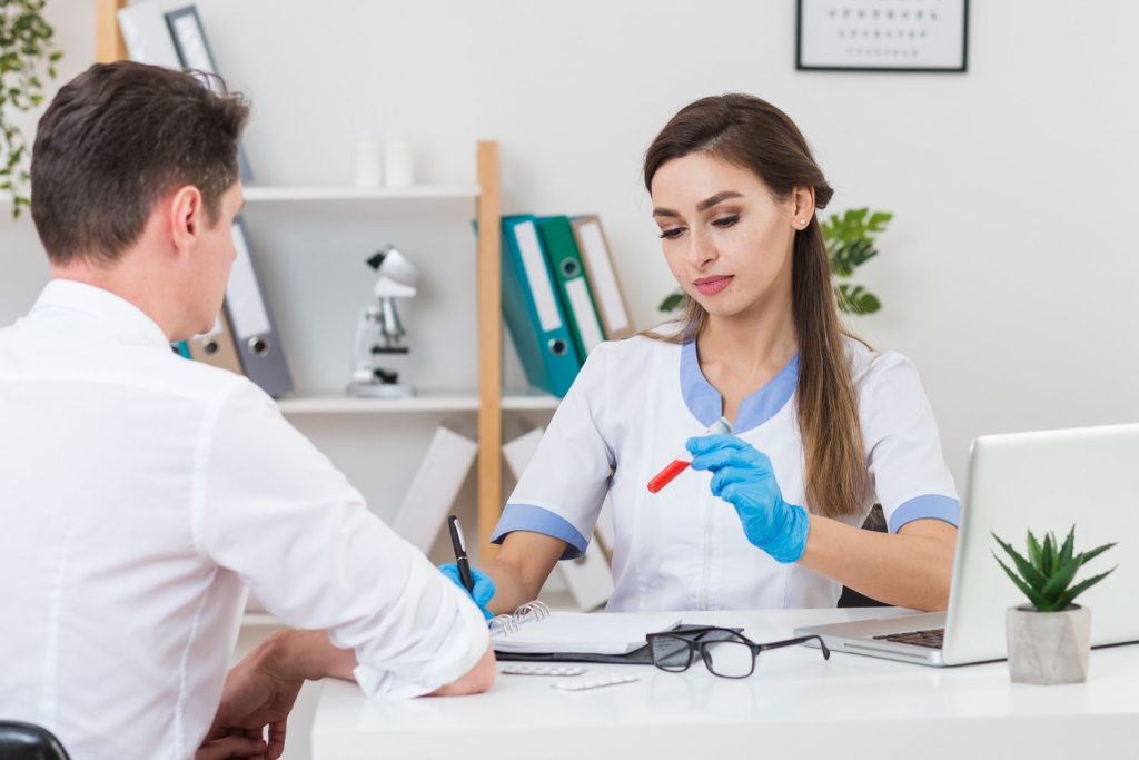 Same day STI test Houston: Technician analyzing blood samples in lab with modern equipment, delivering quick STI test results in Houston.