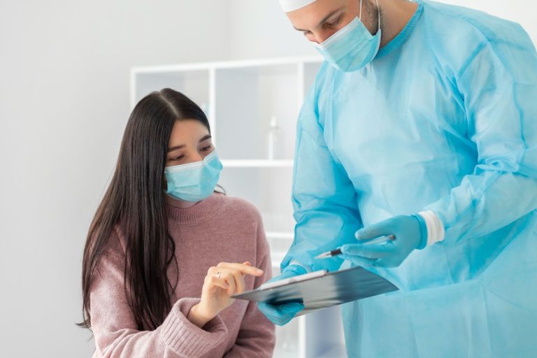 Same day STD test Houston: Doctor in protective gear reviewing clipboard with masked patient in a clean clinic setting, ensuring rapid and confidential testing.