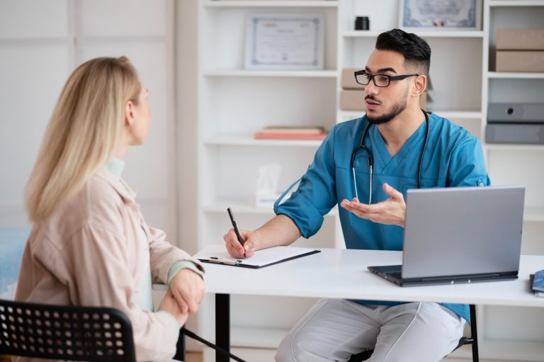 Same day STD test Houston: Doctor consulting patient with laptop in modern clinic, offering quick testing services.