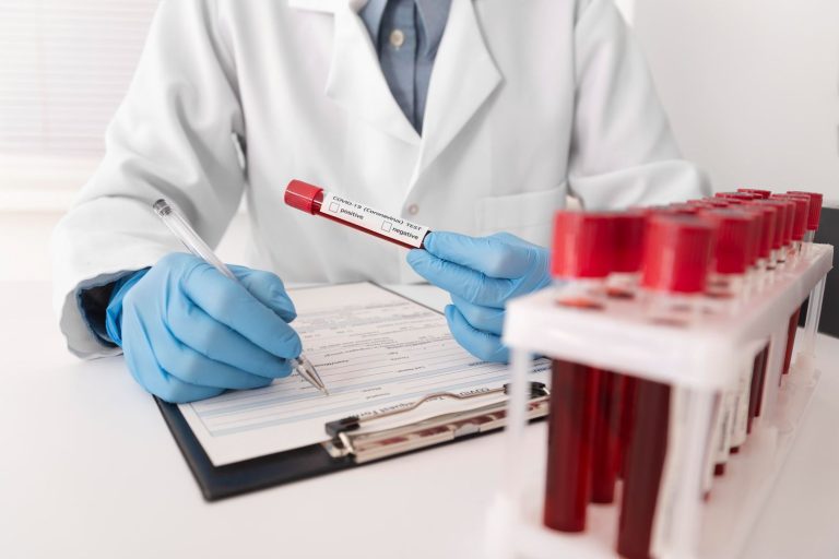Same day STI test Houston: Doctor documenting results with blood vials, providing efficient STI testing and consultation in Houston.