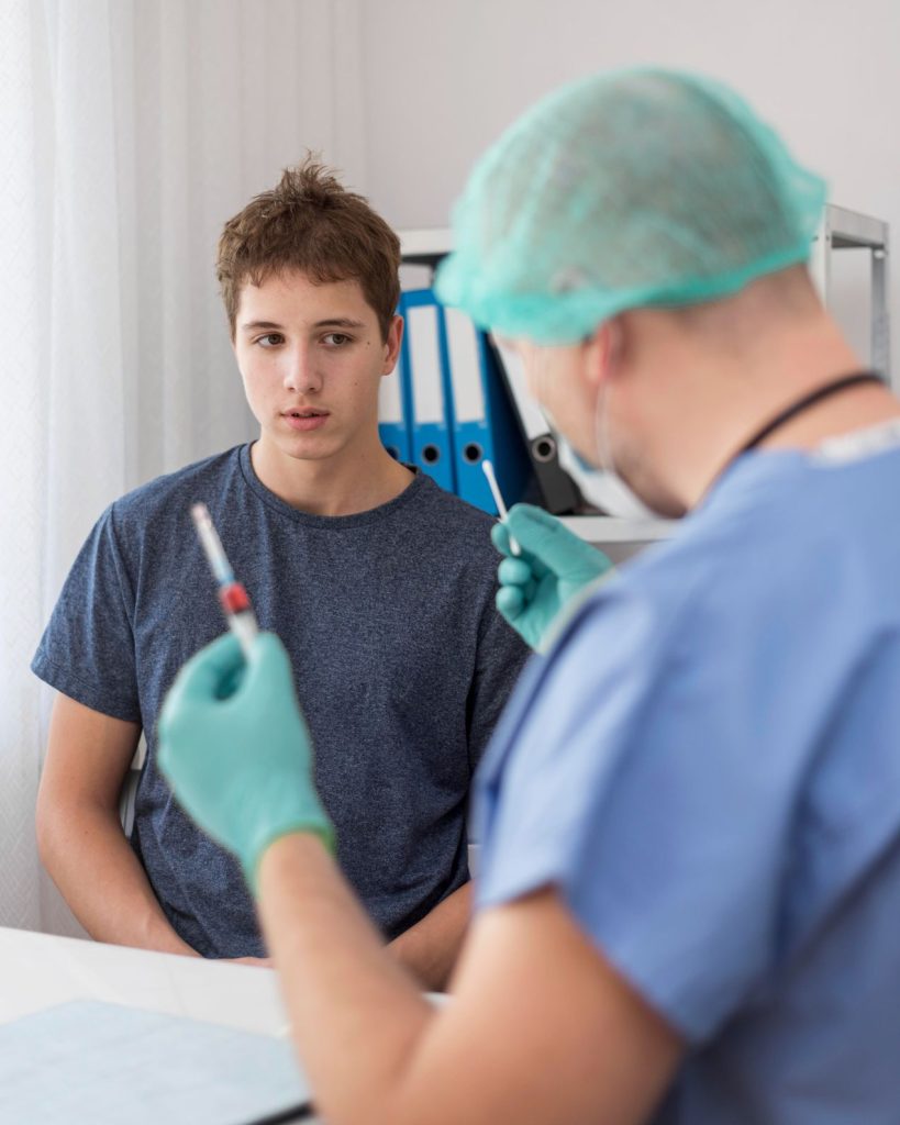 Same day STD test Houston: Young patient with doctor handling blood sample for fast STD testing in a clean office.
