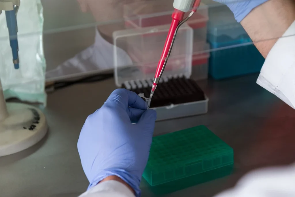 Lab technician handling blood samples for confidential and affordable STD testing Houston.