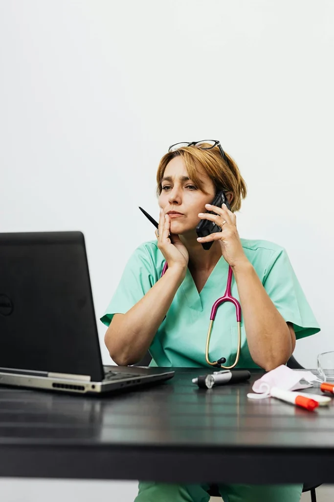 Nurse on phone managing televisit appointments for confidential and affordable STI testing Houston.