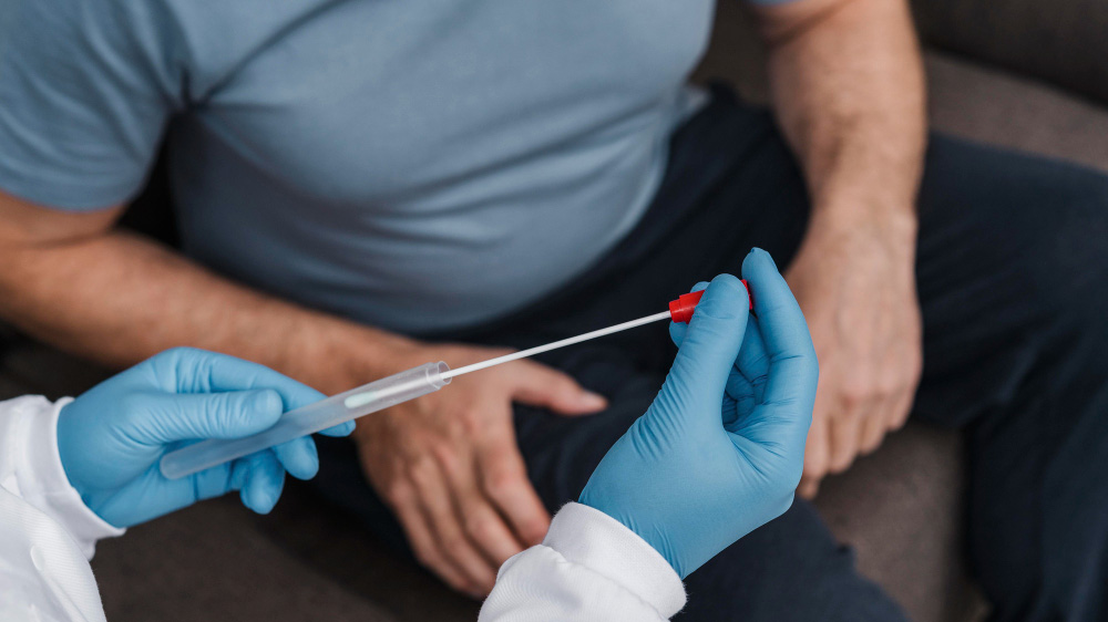 Same day STD test Houston, clinician collects sample with swab and test tube, seated patient, fast and accurate diagnostics.