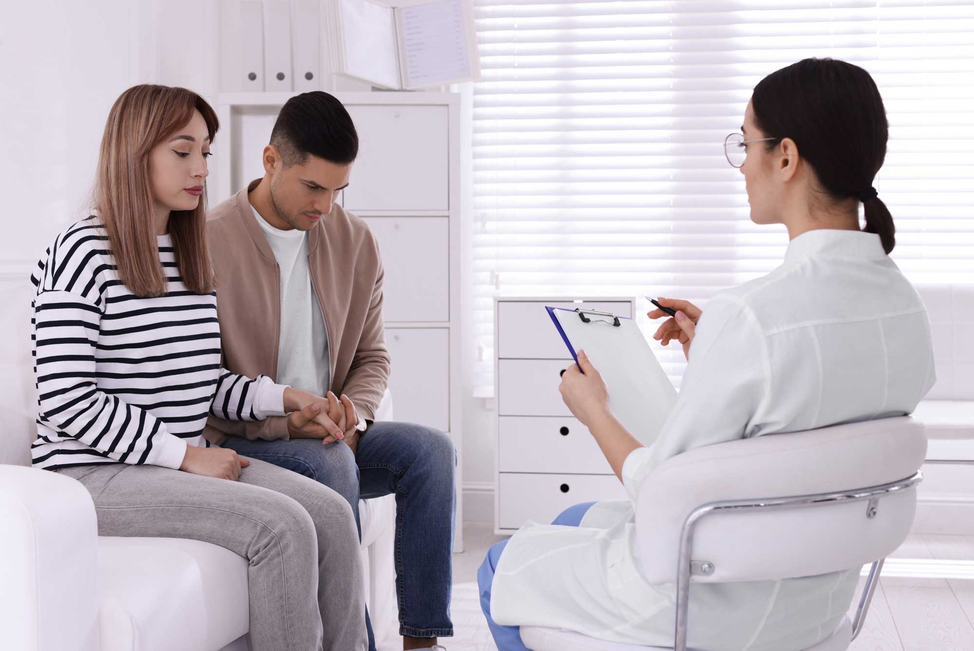 Medical professional at an STD clinic discussing test results and swab procedures with a couple during a consultation.