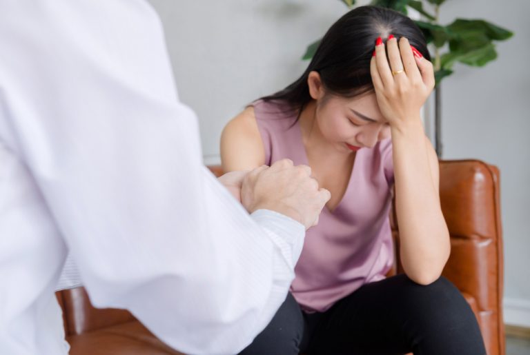A healthcare provider offering comfort and support to an anxious patient during a same day STI test Houston clinic visit.