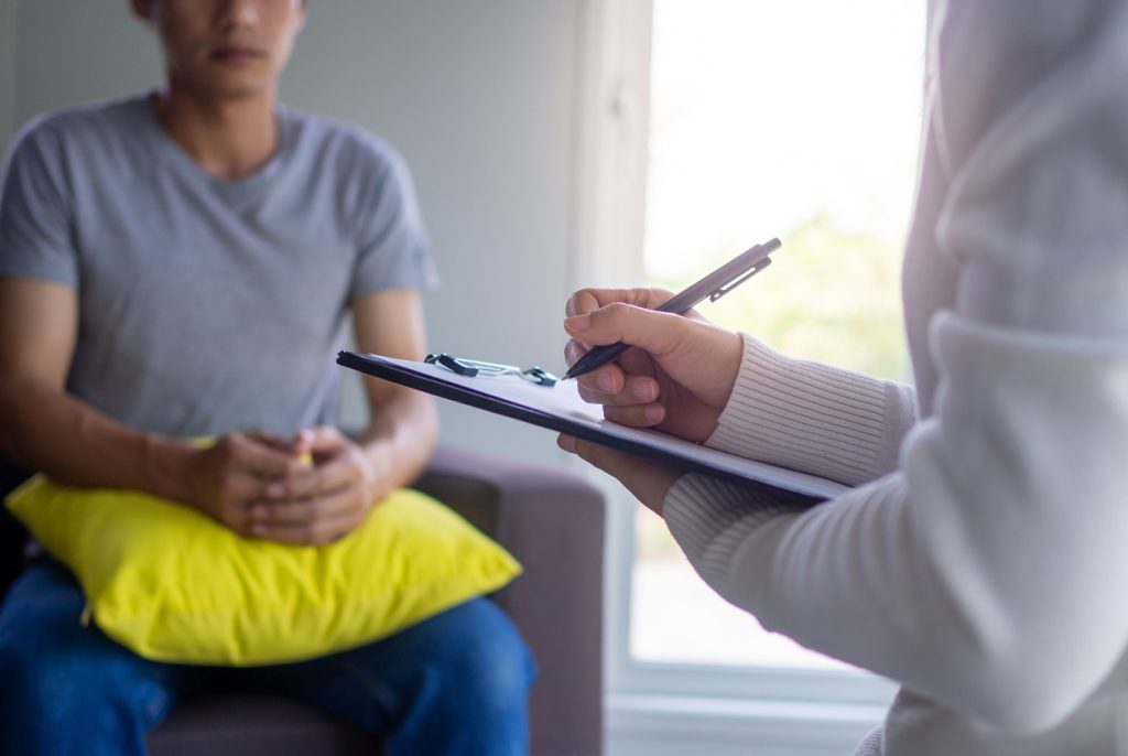 A medical professional taking notes during a private consultation for a same day STI test Houston at a local wellness center.