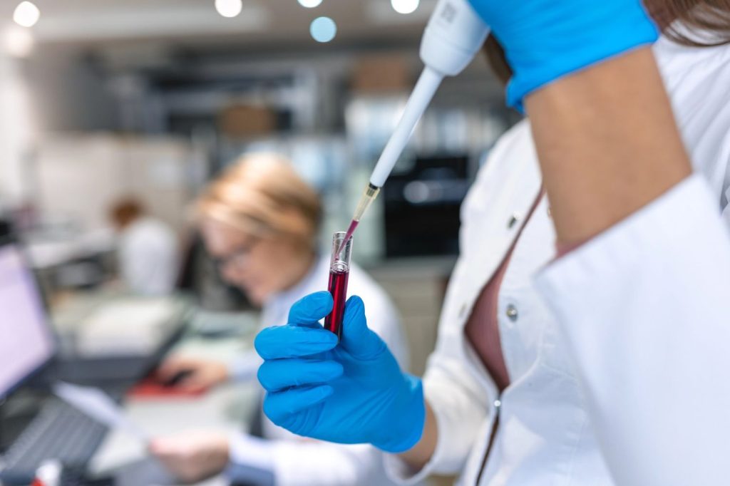 Lab professional processing a blood sample for cheap STD testing Houston clinics provide for patient wellness.