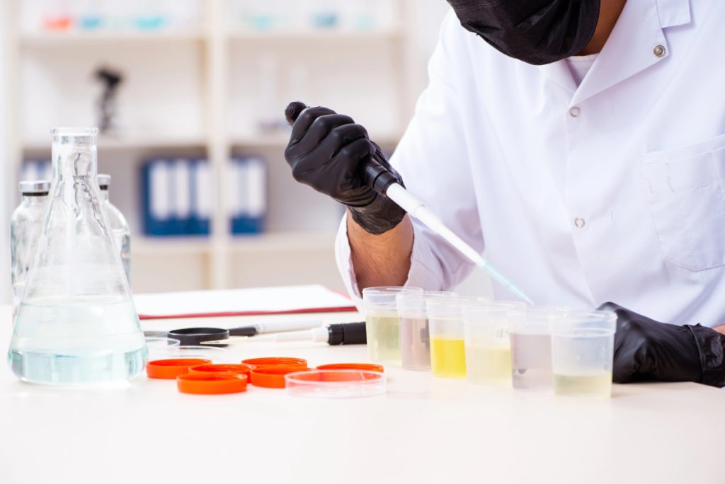 A lab technician performs a urine screening analysis during a standard STD testing Houston clinic appointment.