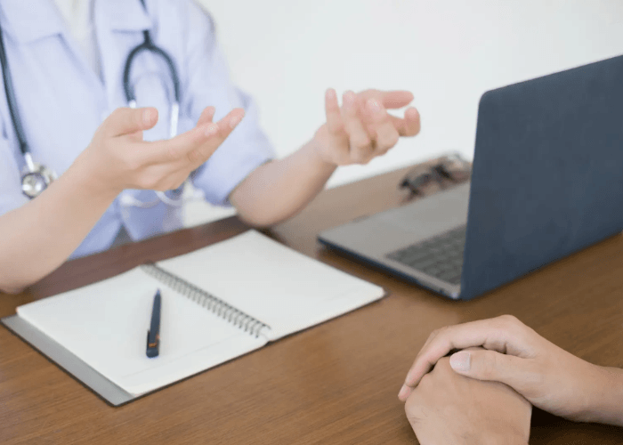 A doctor explains private results during an appointment for std testing houston in a modern medical office setting.